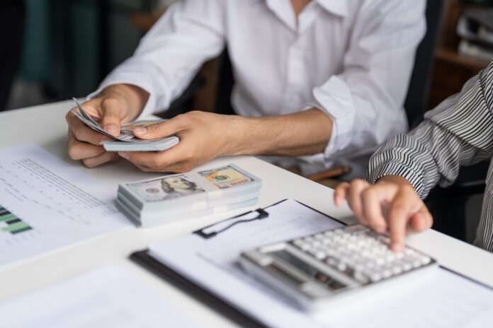 Business People Accountant Counting Banknotes During Cash Audit with Cash Flow Management Holding and Giving Dollar Banknotes cash flow