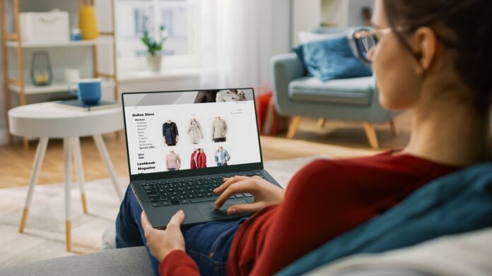 Young Woman at Home Using Laptop Computer for Browsing Through O